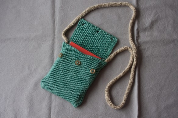 a small bag with i-cord and buttons